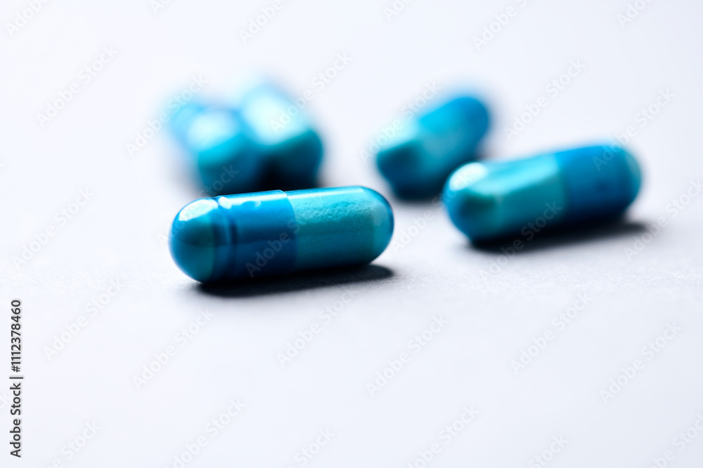 Amino acids capsules on paper background. Soft focus. Close up. Copy space. Amino acids capsules on paper background. Soft focus. Close up. Copy space.