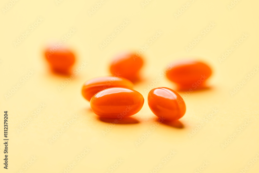 Coenzyme Q10 capsules. Antioxidants. Concept for a healthy dietary supplementation. Bright paper background. Soft focus. Close up. Copy space. Coenzyme Q10 capsules. Antioxidants. Concept for a healthy dietary supplementation. Bright paper background. Soft focus. Close up. Copy space.