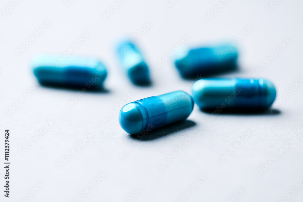 Amino acids capsules on paper background. Soft focus. Close up. Copy space. Amino acids capsules on paper background. Soft focus. Close up. Copy space.