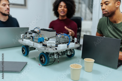 Engineers collaborating on a robotics project, building and programming a robot prototype photo