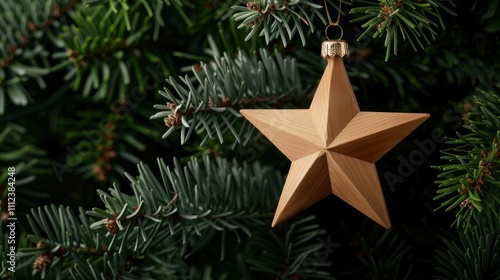 A wooden star ornament hangs from a green Christmas tree, showcasing festive decor and natural beauty.