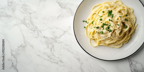 Spaghetti Carbonara plated elegantly on a marble surface, creamy sauce, top view, blank space for text. photo