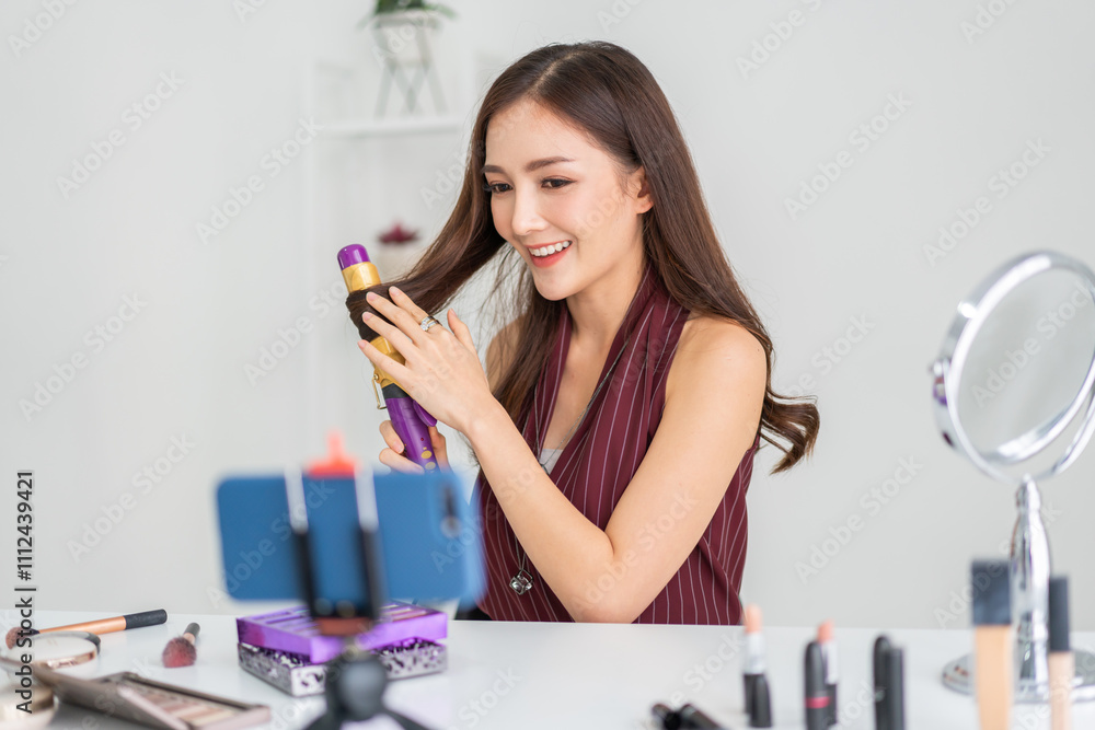 Woman asian beauty blogger live streaming show hair styling techniques using curling iron for hairstyling, influencer content creation, online beauty tips, hair care tutorials, social media engagement Woman asian beauty blogger live streaming show hair styling techniques using curling iron for hairstyling, influencer content creation, online beauty tips, hair care tutorials, social media engagement