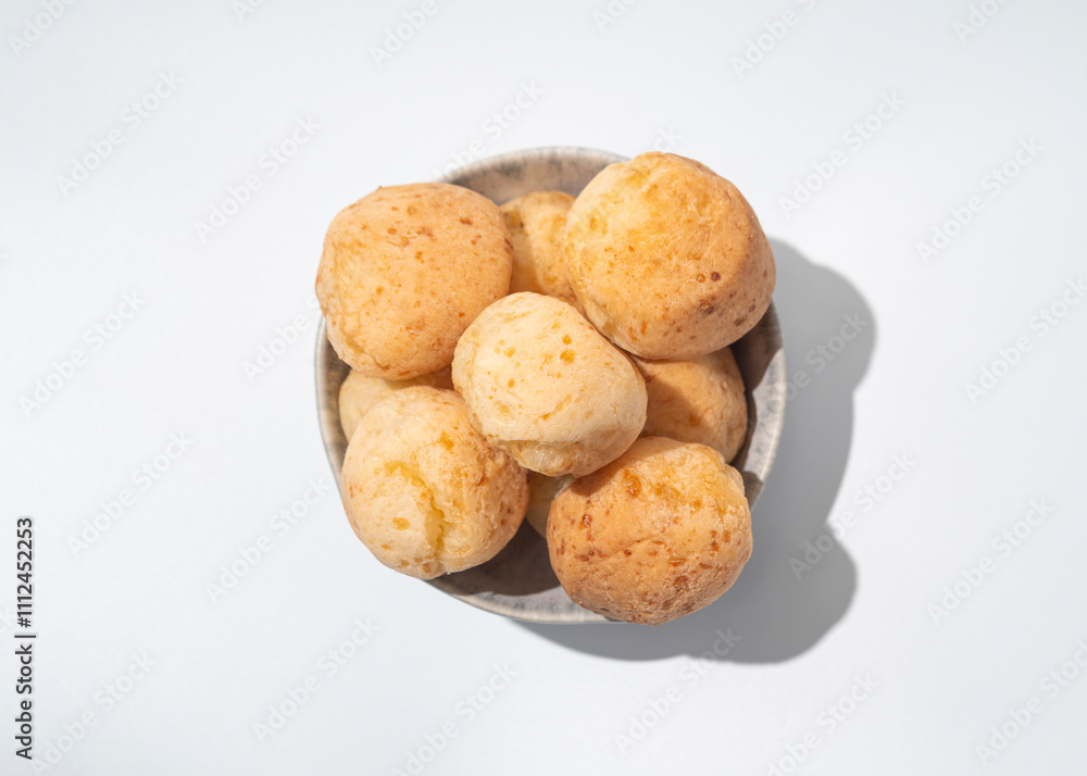 Cheese bread in the bowl, Brazilian pao de queijo mineiro, top view, white background Cheese bread in the bowl, Brazilian pao de queijo mineiro, top view, white background