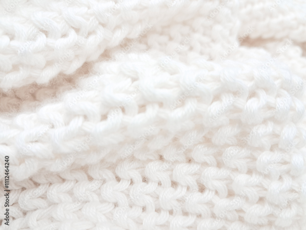 An artistic white knitted plaid background, combining texture and modern minimalist style. An artistic white knitted plaid background, combining texture and modern minimalist style.
