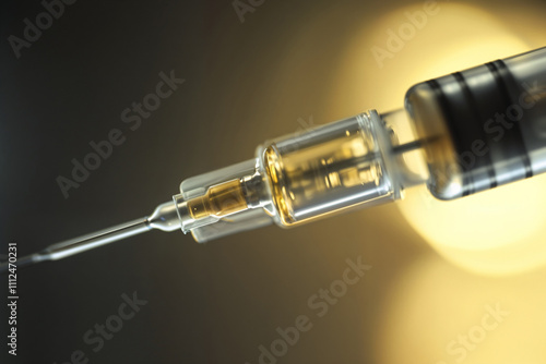 Close-up of syringe needle with liquid and blurred background