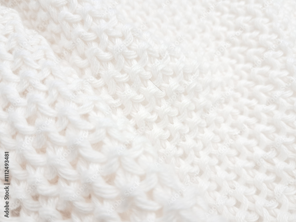 An artistic white knitted plaid background, combining texture and modern minimalist style. An artistic white knitted plaid background, combining texture and modern minimalist style.