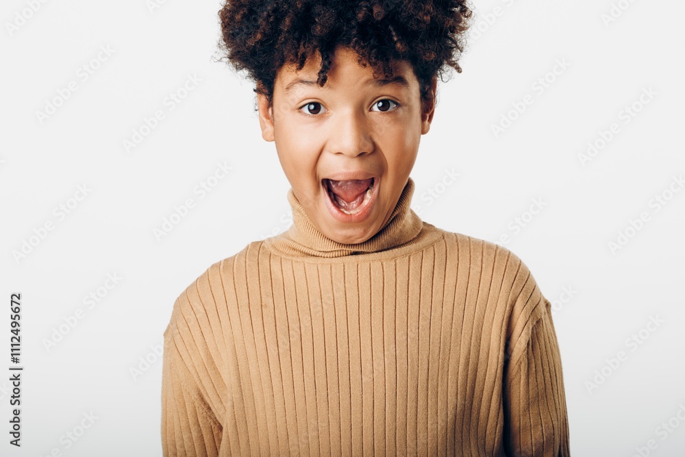 A young african american boy with a surprised expression, mouth open in amazement, capturing a moment of pure wonder A young african american boy with a surprised expression, mouth open in amazement, capturing a moment of pure wonder