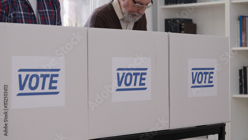 Billede på lærred Close-up of men casting their votes at the polling place, fulfilling their civic
