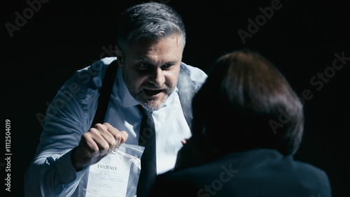 Angry investigator yells at a scared witness, showing an evidence bag, illustrating power abuse