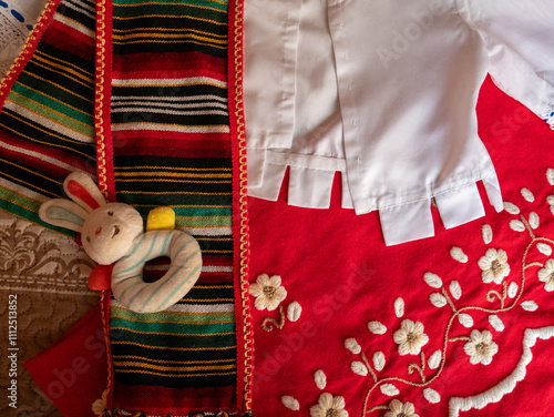 Traje tradicional del sur de España en color rojo y bordado a mano con juguete de conejo photo