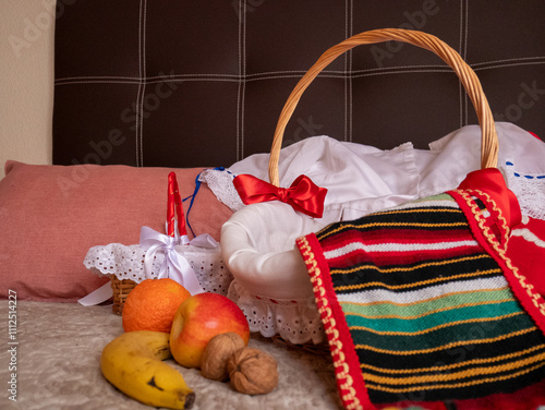 Traje tradicional del sur de España en color rojo y bordado a mano con cesta de mimbre y fruta photo