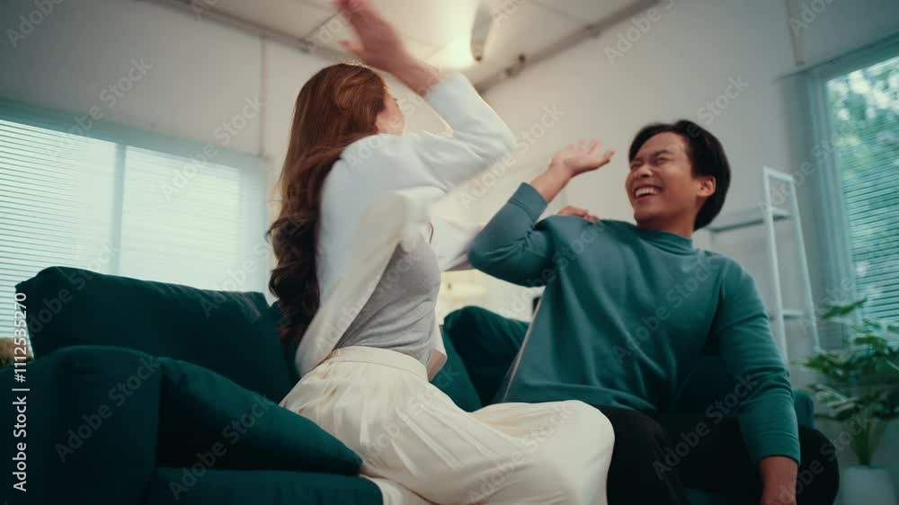 Man and a woman are sitting on a couch, watching television. They are experiencing a range of emotions, from fear to excitement to joy Man and a woman are sitting on a couch, watching television. They are experiencing a range of emotions, from fear to excitement to joy