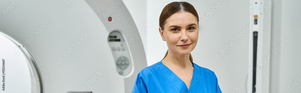 Attractive female doctor in blue scrubs stands confidently near MRI machine in hospital. Attractive female doctor in blue scrubs stands confidently near MRI machine in hospital.