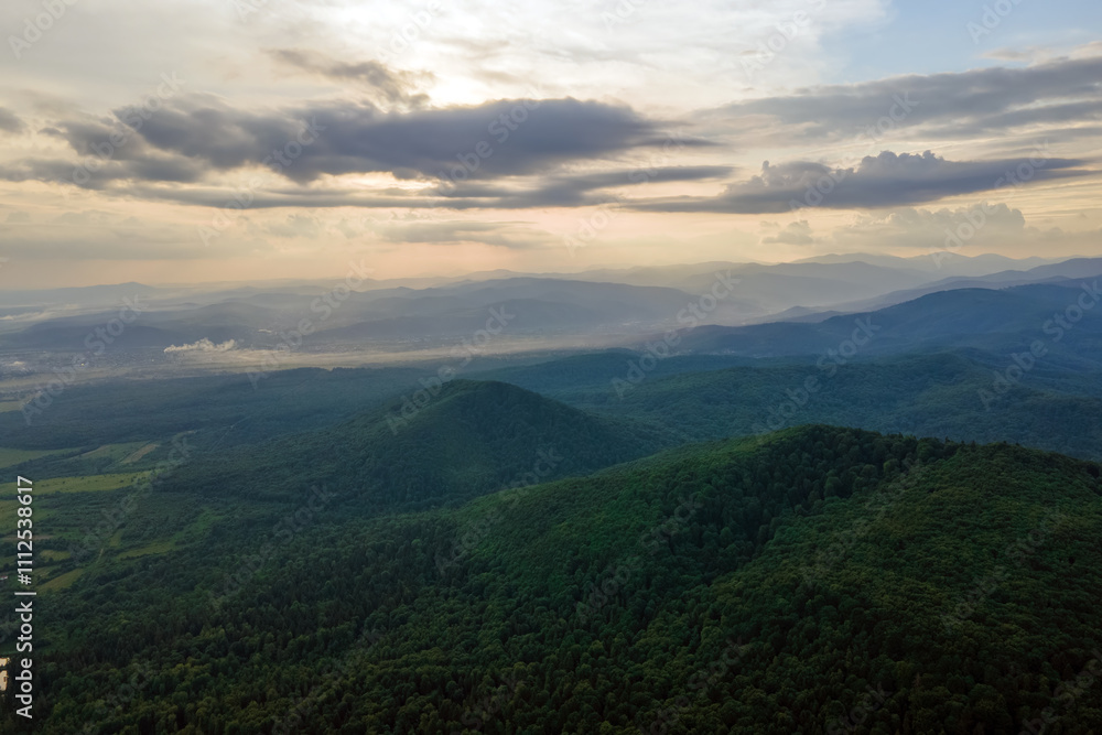 Aerial view of green pine forest with dark spruce trees covering mountain hills. Nothern woodland scenery from above Aerial view of green pine forest with dark spruce trees covering mountain hills. Nothern woodland scenery from above