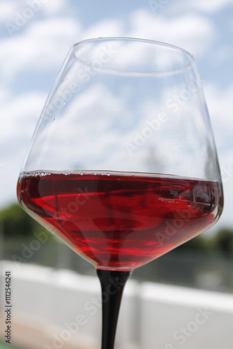 Close-up photo of a glass of red wine outdoors