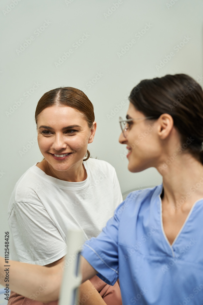 A healthcare professional discusses health concerns with a female patient in a cozy clinic. A healthcare professional discusses health concerns with a female patient in a cozy clinic.