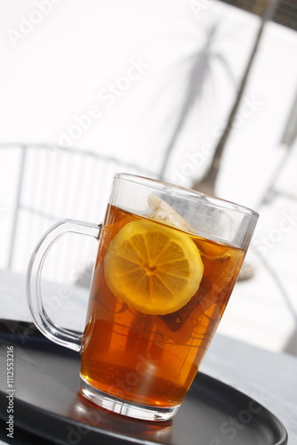 Close-up of  a cup of tea with lemon outdoors