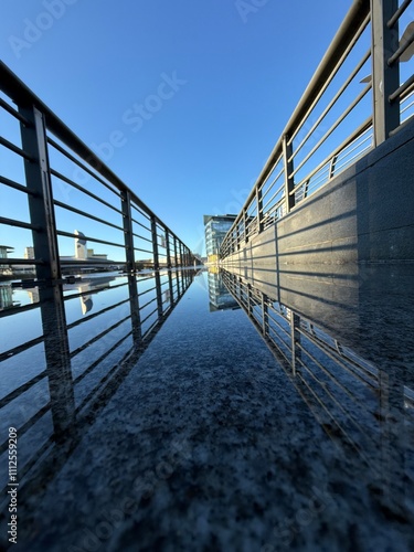 Photography Walkway with metal fencing and reflections in the water