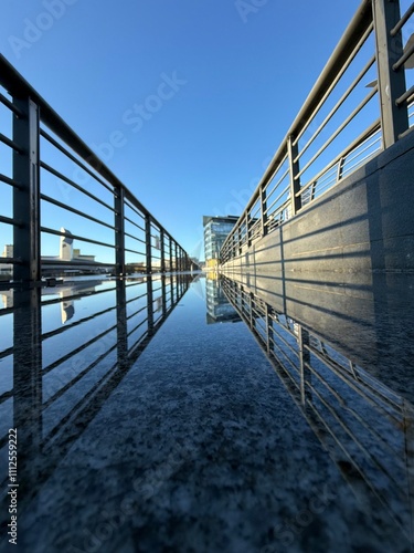 Photography Walkway with metal fencing and reflections in the water
