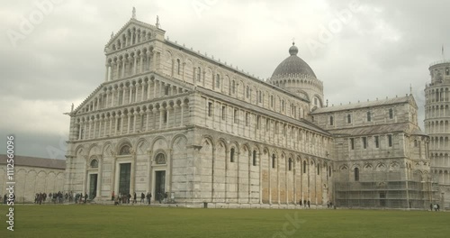 Unesco site. Piazza dei Miracoli.Baptistery, Leaning Tower of Pisa and Pisa Cathedral in white marble stand out on a green lawn. Italy