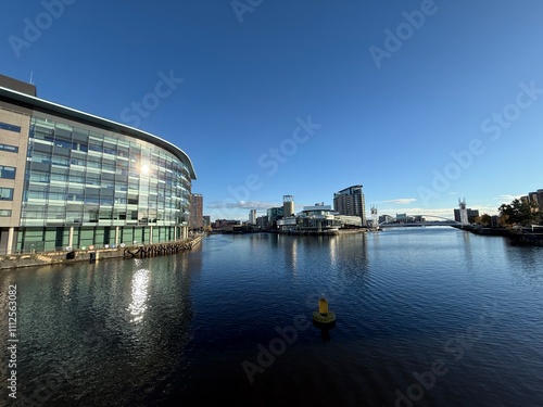 Photography Modern buildings and landmarks next to the water with a clear blue sky background
