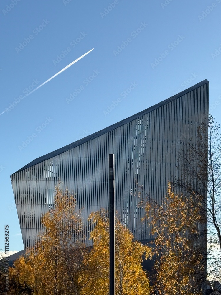 Modern building with trees in the front and a clear blue sky background. Taken in Salford Quays Manchester England. Modern building with trees in the front and a clear blue sky background. Taken in Salford Quays Manchester England.