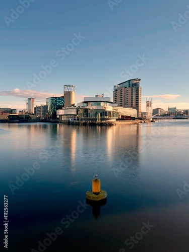 Photography Modern buildings and landmarks next to the water with a clear blue sky background