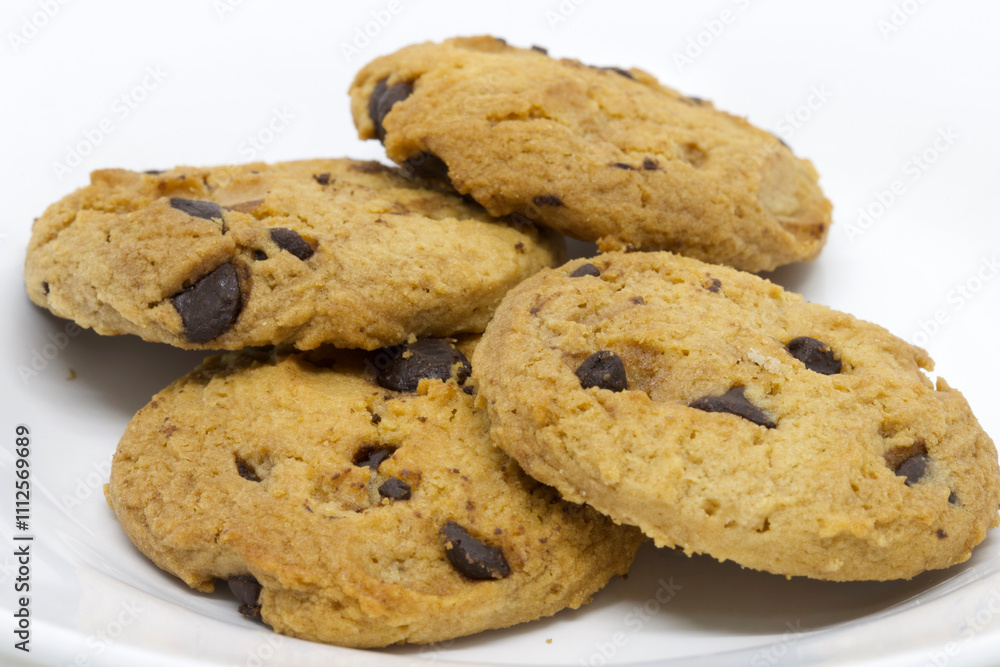 A tempting close-up image showcasing a stack of homemade chocolate chip cookies on a white plate, highlighting their golden-brown color and rich chocolate chunks. A tempting close-up image showcasing a stack of homemade chocolate chip cookies on a white plate, highlighting their golden-brown color and rich chocolate chunks.