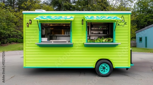 Frogthemed food truck with a green design and popup serving window shaped like a mouth, offering fresh salads photo