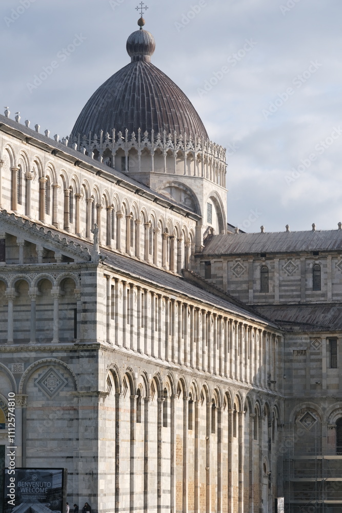 Fototapeta premium Pisa Cathedral. White marble facade of the cathedral.Pisan Romanesque style arcades with columns and arches. Italy