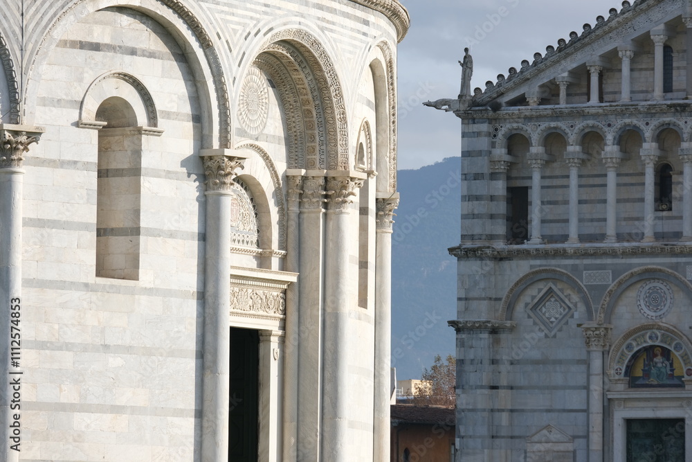 Romanesque architecture. Decorations on marble facades. Detail of the baptistery and the cathedral of Pisa with decorations in Romanesque style. Italy Romanesque architecture. Decorations on marble facades. Detail of the baptistery and the cathedral of Pisa with decorations in Romanesque style. Italy