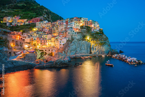 Illuminated clifftop Townscape at dusk, Manarola, La Spezia, Liguria, Italy photo