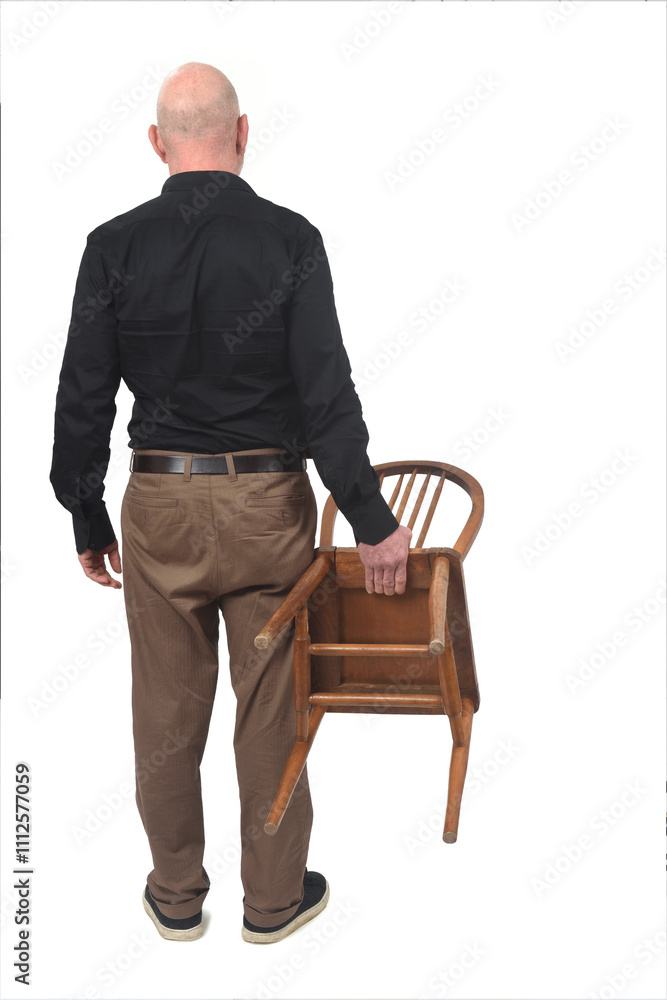 back view of a standing man holding wooden chair on white background back view of a standing man holding wooden chair on white background