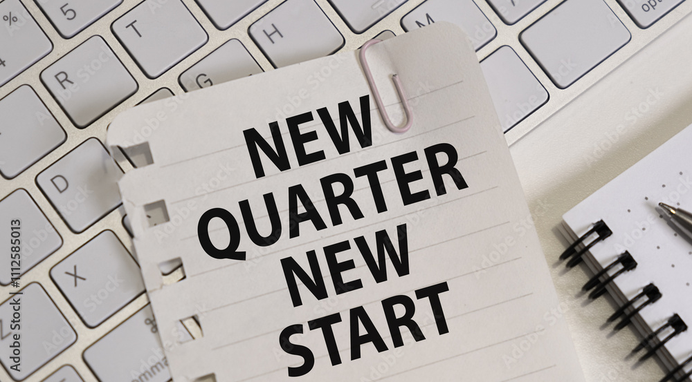 NEW QUARTER NEW START text on Notepad on Planning and Keyboard, White Background NEW QUARTER NEW START text on Notepad on Planning and Keyboard, White Background