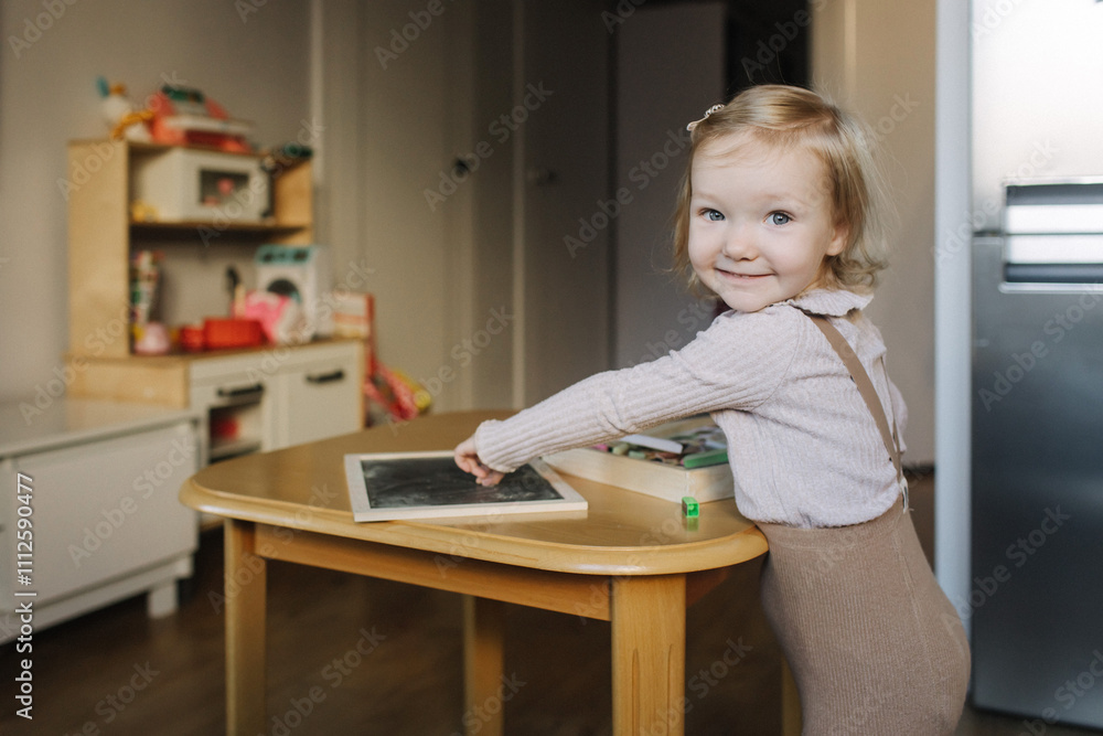 Portrait of toddler girl playing with toys in playroom. Adorable two years old girl at home, enjoying creative playtime in a bright, cozy environment. Generation alpha concept. Part of a series Portrait of toddler girl playing with toys in playroom. Adorable two years old girl at home, enjoying creative playtime in a bright, cozy environment. Generation alpha concept. Part of a series