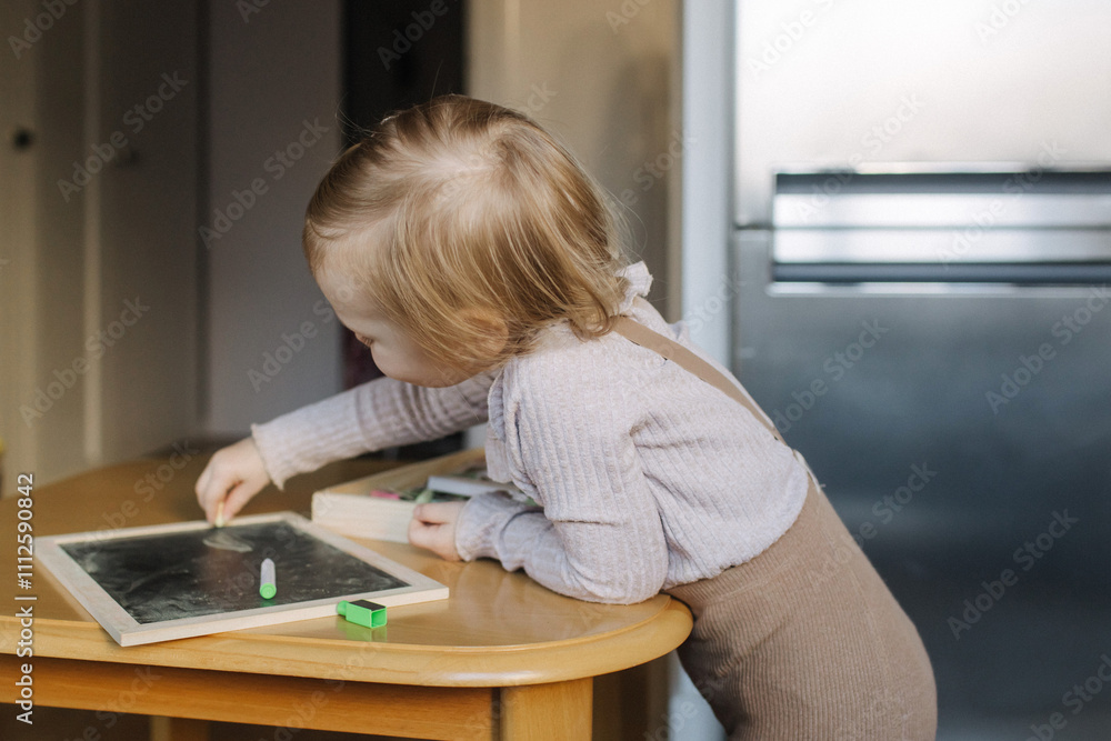 Portrait of toddler girl playing with toys in playroom. Adorable two years old girl at home, enjoying creative playtime in a bright, cozy environment. Generation alpha concept. Part of a series Portrait of toddler girl playing with toys in playroom. Adorable two years old girl at home, enjoying creative playtime in a bright, cozy environment. Generation alpha concept. Part of a series