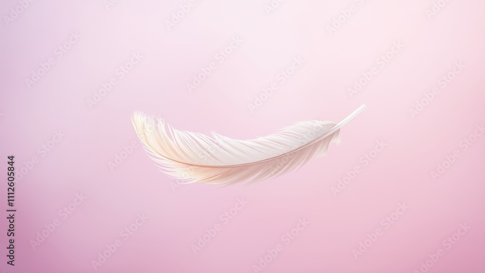 Obraz premium A single delicate white feather floats gracefully against a soft pink background, showcasing the beauty of simplicity and the ephemeral nature of life.