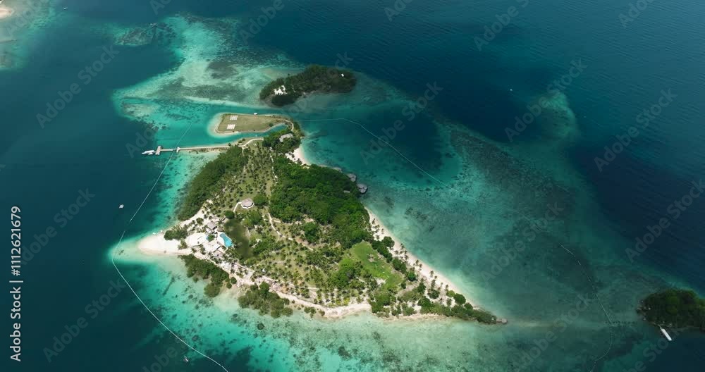 Aerial survey of white beach surrounded with azure water and waves. Malipano Islets in Samal. Davao, Philippines.