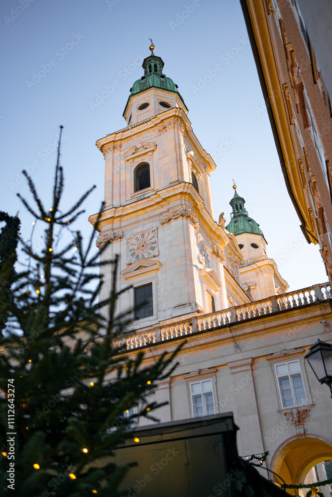Fototapeta premium Square (Residenzplatz) with Christmas decorations in the old town of Salzburg. Christmas tree near Salzburg Cathedral. The atmosphere of the Christmas holidays in a European city