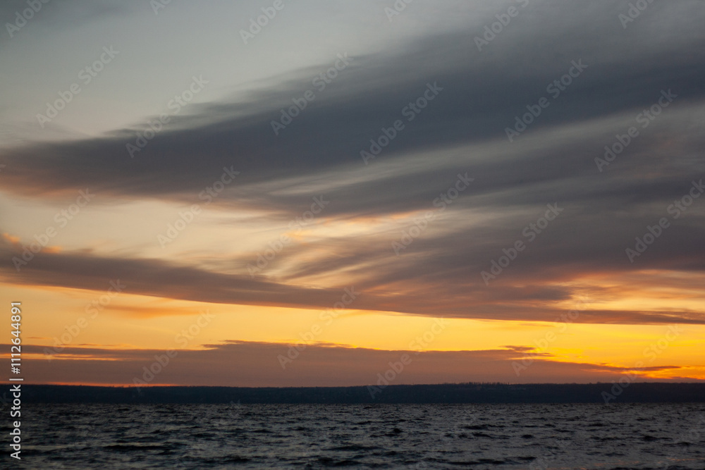 a sunset with clouds and a sunset on the horizon. a sunset with clouds and a sunset on the horizon.