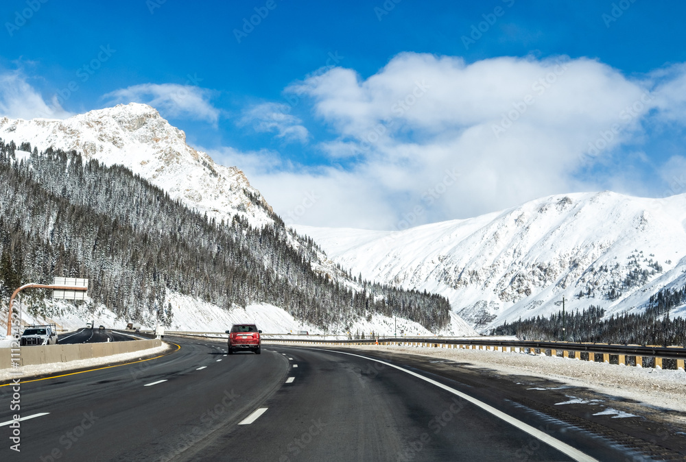 driving along a road in the Rocky Mountains in snow driving along a road in the Rocky Mountains in snow