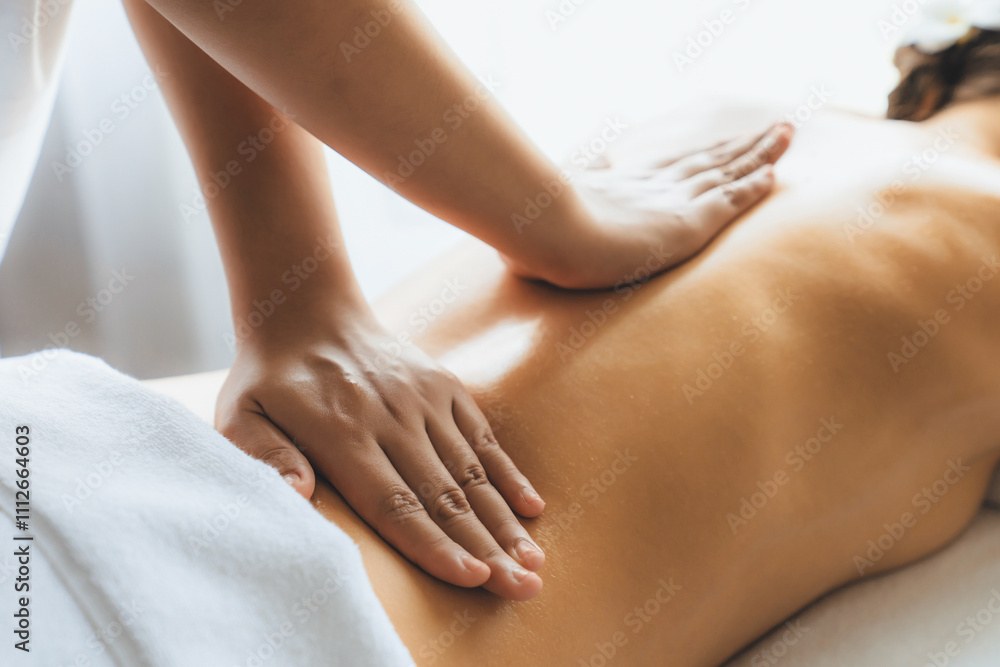 Closeup woman customer enjoying relaxing anti-stress spa massage and pampering with beauty skin recreation leisure in day light ambient salon spa at luxury resort or hotel. Quiescent Closeup woman customer enjoying relaxing anti-stress spa massage and pampering with beauty skin recreation leisure in day light ambient salon spa at luxury resort or hotel. Quiescent
