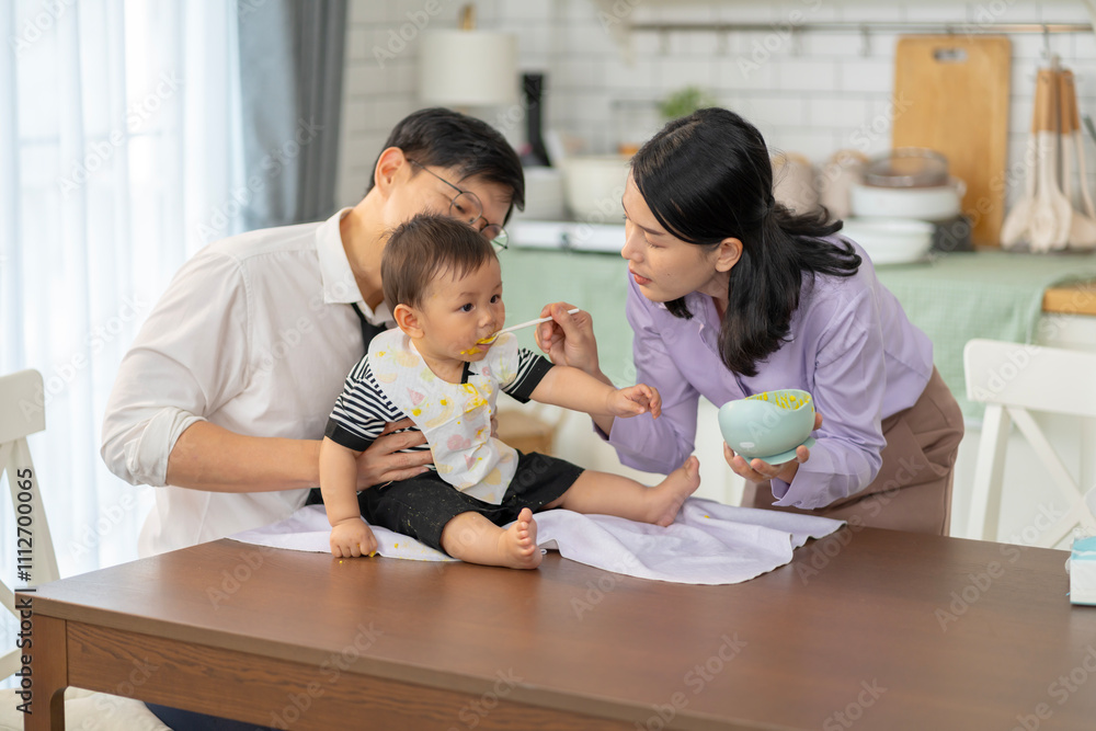 Fototapeta premium Asian baby and families who have to work while raising children at home