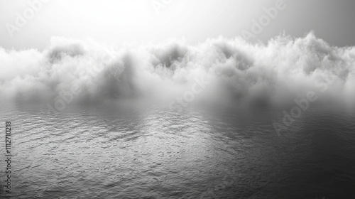 Moody landscape of fog hovering over calm waters during early morning light