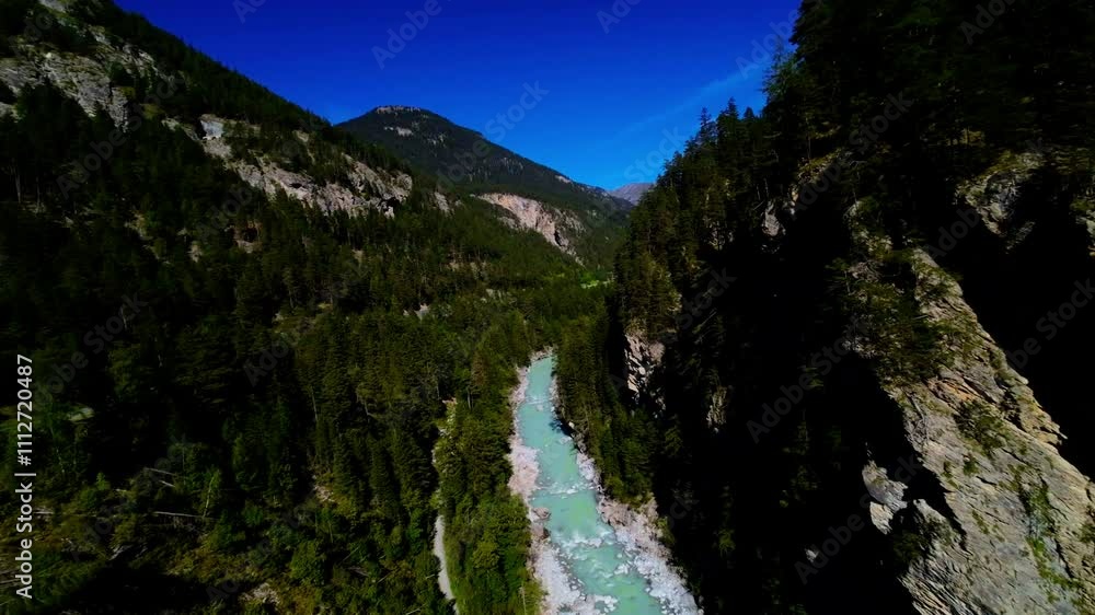 Stunning aerial view of a turquoise river winding through mountainous terrain with lush forests in a serene landscape Stunning aerial view of a turquoise river winding through mountainous terrain with lush forests in a serene landscape