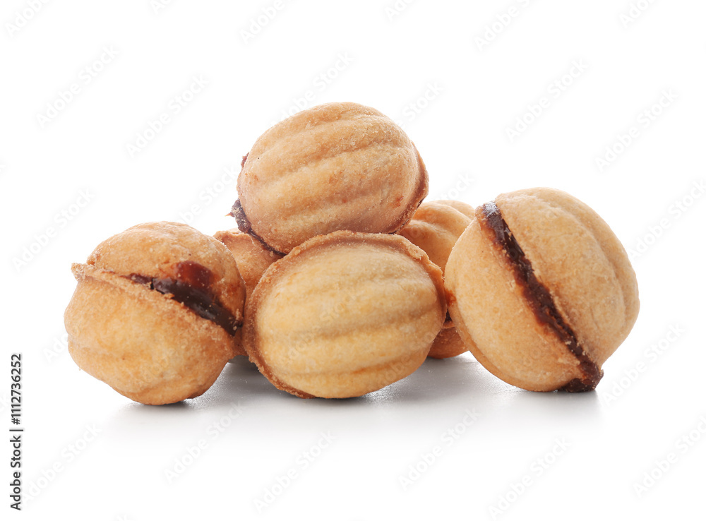 Many sweet walnut shaped cookies with boiled condensed milk on white background Many sweet walnut shaped cookies with boiled condensed milk on white background