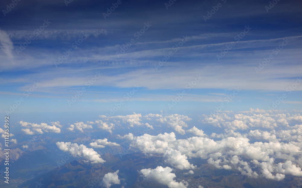 view from the window of an airliner with white clouds below view from the window of an airliner with white clouds below