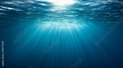 Sunlight filtering through ocean surface creating beautiful underwater beams