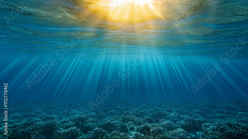 Sunlight piercing ocean surface illuminating coral reef